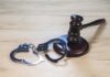 Gavel and handcuffs on wooden table