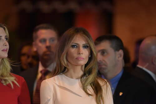 Melania Trump at an event with a crowd in the background